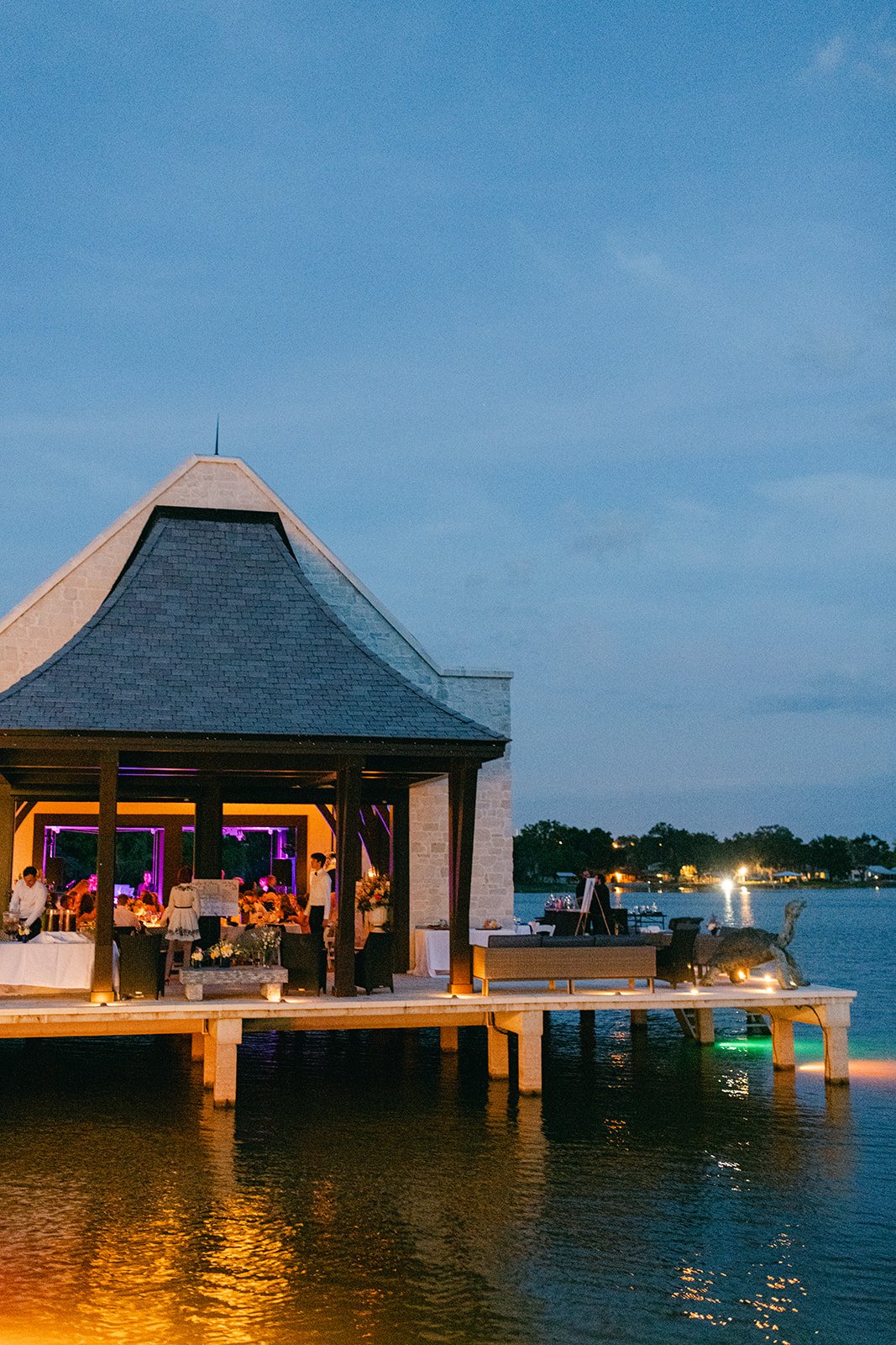 Lakefront pavilion illuminated at night at The Place at Lake Placid